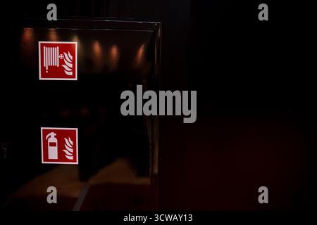 Fire Safety Signs Displayed on a Dark Background for Enhanced Visibility and Awareness Stock Photo