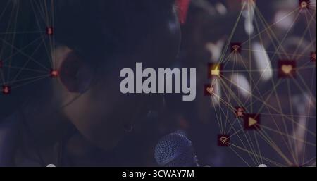 Singing Chinese performer holding wired mesh mic on stage, with glowing social media icons overlay Stock Photo