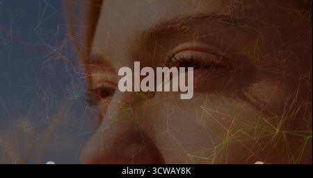 Showcasing adult woman's face and eyes in abstract backdrop, with translucent network overlay Stock Photo