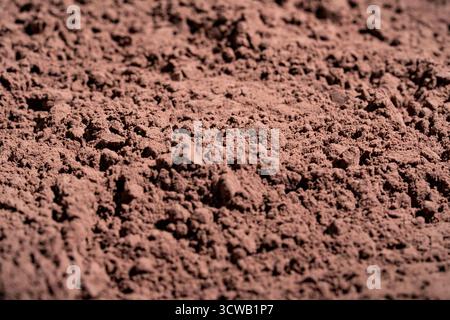 Natural dark brown cocoa powder textured background, close up Stock Photo