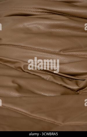 Fragment of a red leather sofa, textured background Stock Photo