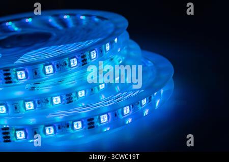 Blue LED strip light roll glowing in the dark modern lighting technology concept Stock Photo