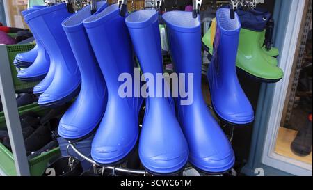 Blue rubber boots in front of the shoe shop, Bad Bevensen, Lower Saxony, Germany Stock Photo