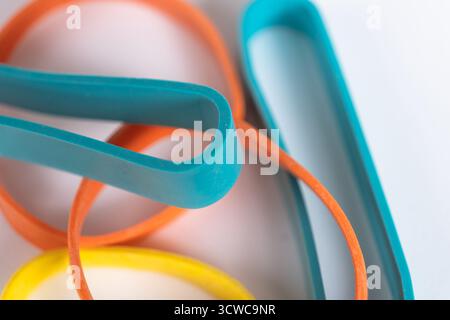 Rubber bands on a white background. Many colorful plastic rubber bands. Close up view Stock Photo