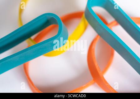 Rubber bands on a white background. Many colorful plastic rubber bands. Close up view Stock Photo