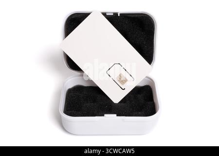 Close-up of a new mobile phone SIM card in its white carrier packaging over an open storage box Stock Photo