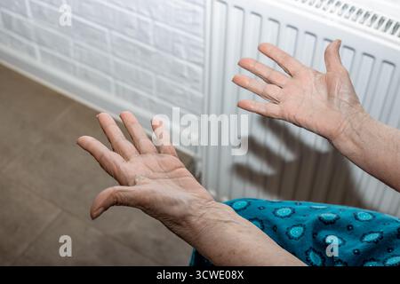 A close-up of an elderly womans outstretched hands with wrinkled skin. Stock Photo