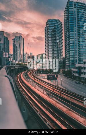 A bustling downtown skyline, with towering buildings and a boardwalk ...