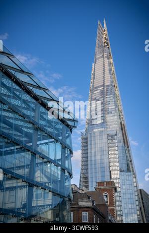 View of The Shard, London’s iconic skyscraper, against a clear blue sky on a sunny day, highlighting its modern glass architecture. Stock Photo