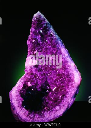 Rocks geology Geode filled with Amethyst Crystals purple crystalline structures cut away open Stock Photo