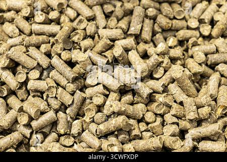 background from a feed additive for raising animals. Wood pellet cat litter, background and texture, top view. Stock Photo