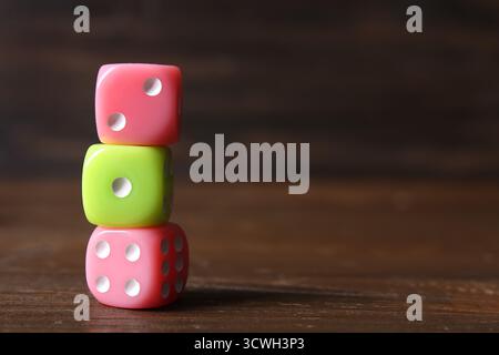 Stack of different game dices on wooden background Stock Photo