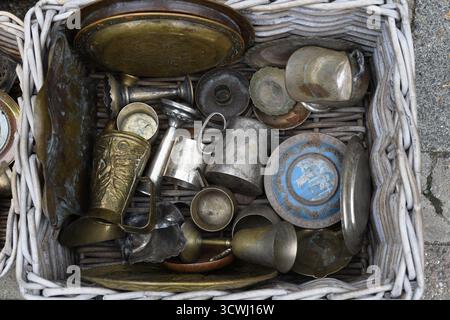 Basket of pewter and brass objects Stock Photo