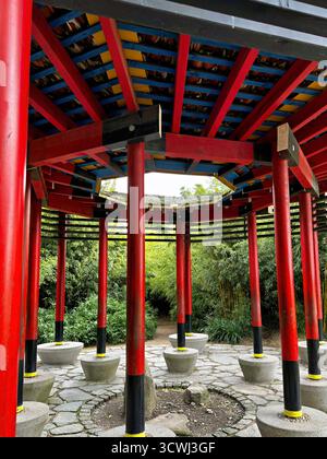 Vibrant Red Pagoda Pavilion In A Lush Japanese Garden Stock Photo
