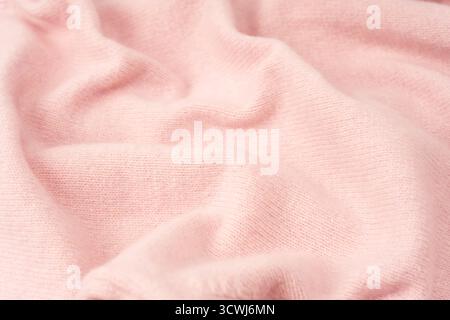 Soft pink cashmere sweater texture background. Top view. Stock Photo