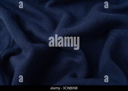 Navy blue merino wool sweater texture as background. Top view. Stock Photo