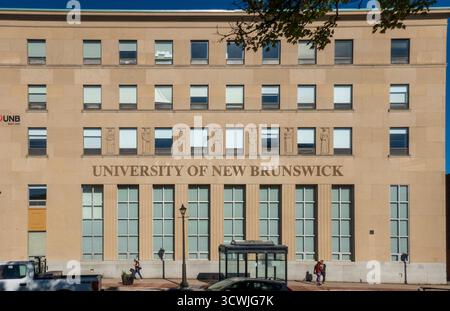 Saint John, NB - CA - Sep 30, 2025 The University of New Brunswick building in Saint John, New Brunswick, Canada, with a bus shelter and people walkin Stock Photo