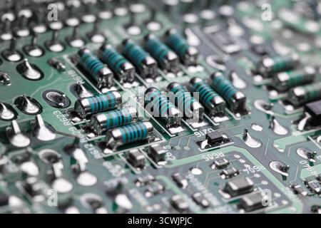 A fragment of a printed circuit board with a group of MELF (Metal Electrode Leadless Face) resistors close-up Stock Photo