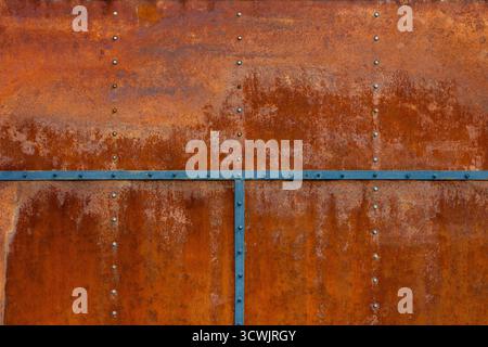 Rusty bolted metal with steel stripes, aged texture, corrosion Stock Photo
