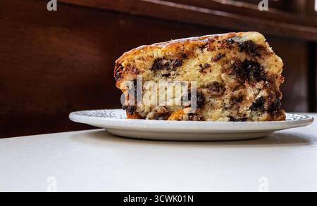 Enjoying a slice of chocolate chip scone A sweet treat for a delightful moment. Stock Photo