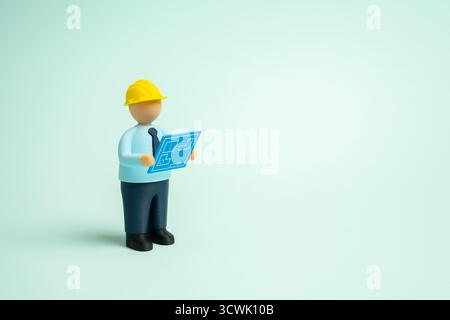 The working designer looks at the blue prints. Construction and design. A concept of project planning, creativity, and technical precision. Topics on Stock Photo