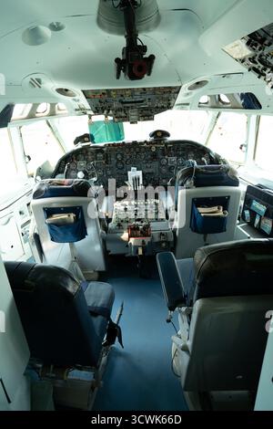 Aircraft cockpit interior showing pilot seats and instrument panel at aviation museum Stock Photo