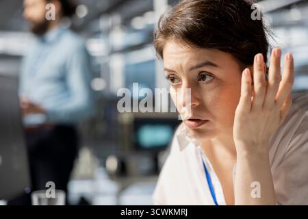 Data center admin inspecting infrastructure, doing maintenance tasks, checking diagnostics. Server hub IT professional conducting system checks to ensure stability across network racks, close up Stock Photo