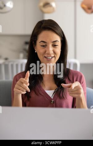 Positive young Latin blogger woman giving workshop Stock Photo