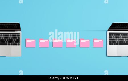 Pink digital folders transferring files between two laptops on a vibrant blue background, representing data sharing and exchange Stock Photo