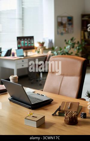 Empty Modern Office Workspace Featuring Laptop and Stationery on Desk Stock Photo