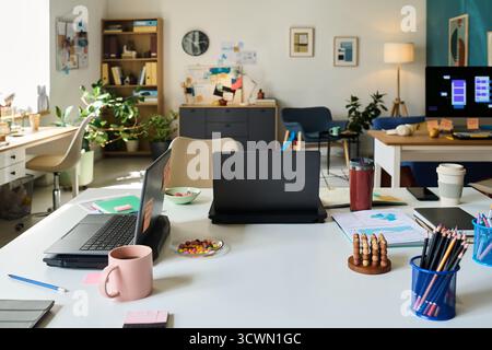 Modern Office Workspace Featuring Laptops and Stationery on Desk Stock Photo