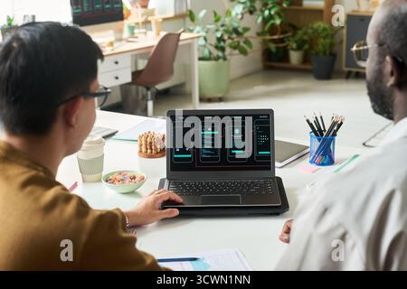 Multiethnic Men Collaborating on Mobile App Interface Design Stock Photo