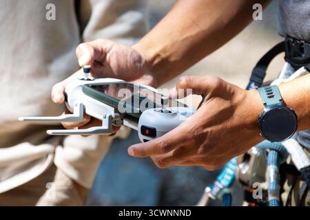 Hands operating drone controller outdoors Stock Photo