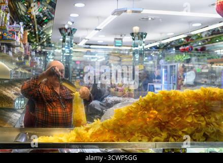 Freshly fried potatoe Crisps for sale in a delicatessan and grocers shop in the center of Madrid, Spain. Stock Photo