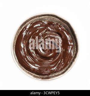 Bowl of melted dark chocolate isolated on white background, top view. Chocolate sauce, design element. Stock Photo