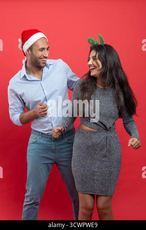 Family celebrating Christmas party dancing in festive hat and headband during New Year’s Eve Stock Photo