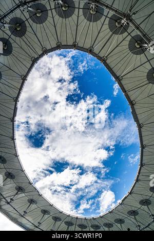 Fragment of a modern building, roof with a hole in the sky with clouds. High quality photo Stock Photo