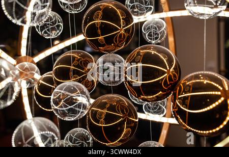 Glass translucent spheres on pendants in white and brown colors in a futuristic style close-up. Stock Photo