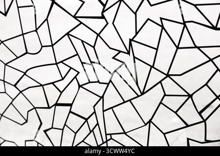 Black polygonal patterns in the form of lines of different geometric shapes on white glass Stock Photo