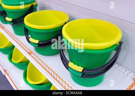 Shelves in the store with plastic utensils. Rack with miscellaneous goods. Sale Stock Photo