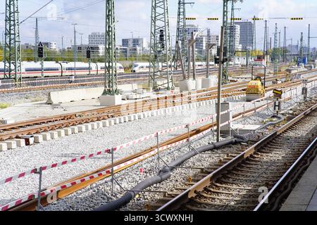 Railway maintenance and track construction on the Munich S-Bahn network with overhead wires and city buildings in the background.Munich,Germany Stock Photo