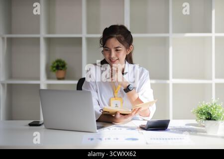 Business woman using calculator for do math finance on wooden desk in office and business working background, tax, accounting, statistics and analytic Stock Photo