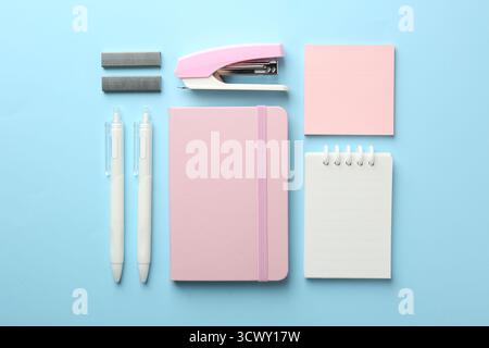 Stapler and other stationery on light blue background, flat lay Stock Photo