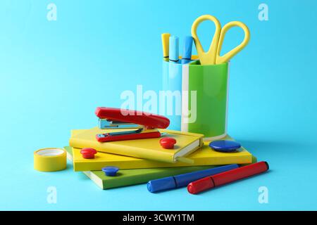 Stapler and other stationery on light blue background Stock Photo
