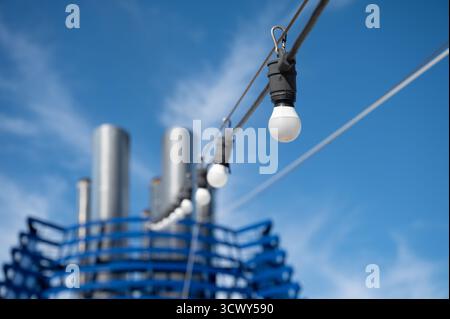 String Lights Leading to Cruise Ship Funnel Against Blue Sky. Selective Focus. Stock Photo
