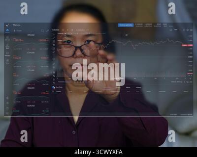 This image depicts a person viewing and interacting with a digital financial trading interface, likely a cryptocurrency trading platform, blur some im Stock Photo