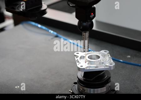 Quality control test of CNC milling process by coordinate measuring machine. Selective focus. Stock Photo