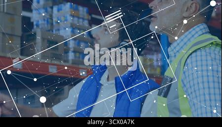 Two warehouse workers wearing vests and headsets scanning shelves in aisle, with digital overlays Stock Photo