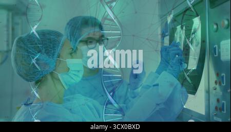 Two surgeons examining medical monitor in operating room, with DNA helix overlay, control panel Stock Photo