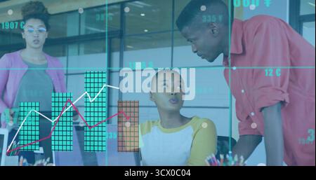 Collaborating team members analyzing data at desk in conference room, with laptop and pen holder Stock Photo